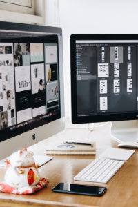 image of two desktop monitors with social photos on the screens